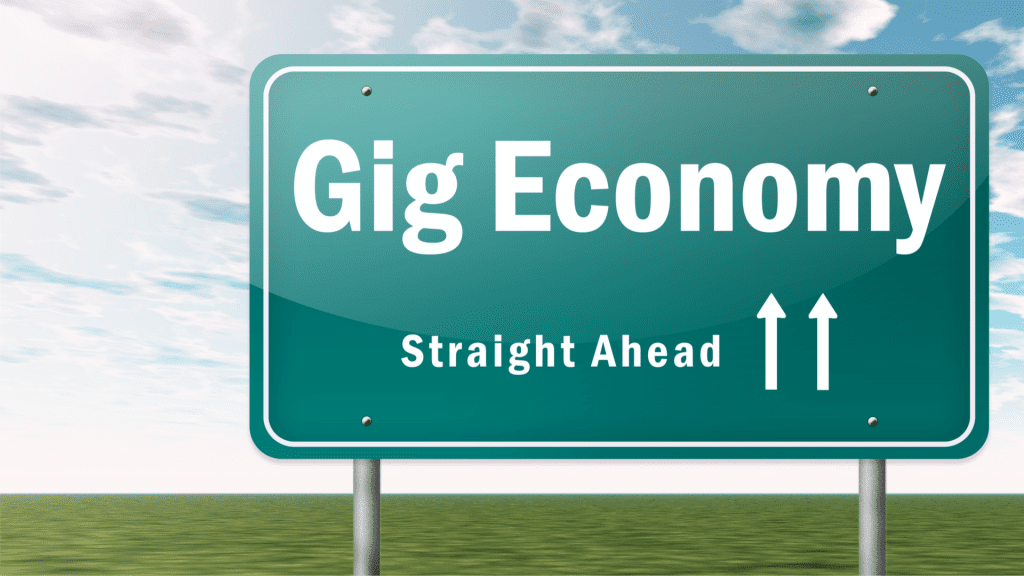 road sign that says "Gig Economy, Straight Ahead" with 2 arrows facing up